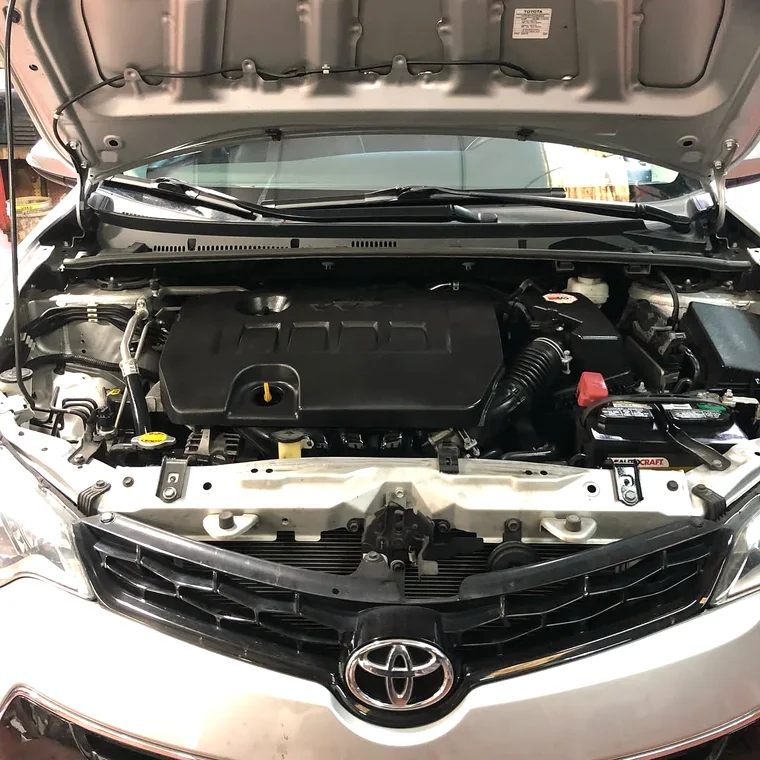 Engine bay with the battery and connections in view